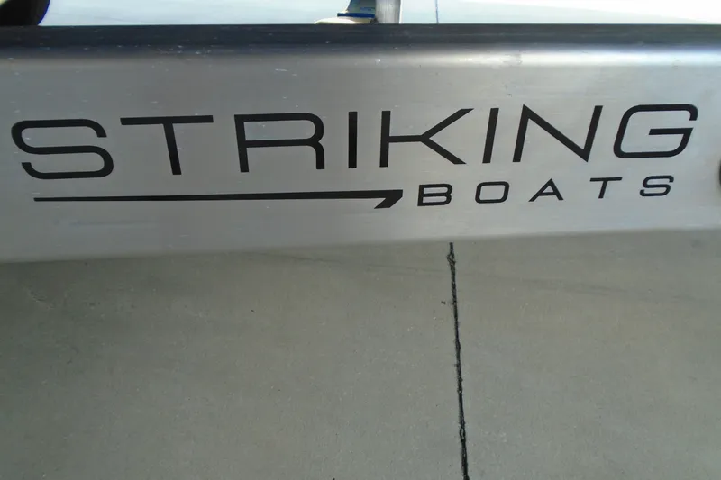 Slide: The Image of STRIKING BOATS 26XB 2027 logo on metallic surface, showcasing modern design. - 20