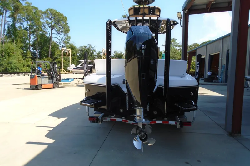 Slide: The Image of 2027 STRIKING BOATS 26XB with powerful outboard motor in a marina setting. - 14