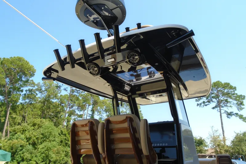 Slide: The Image of 2027 STRIKING BOATS 26XB with advanced fishing rod holders and sleek design under clear blue sky. - 12