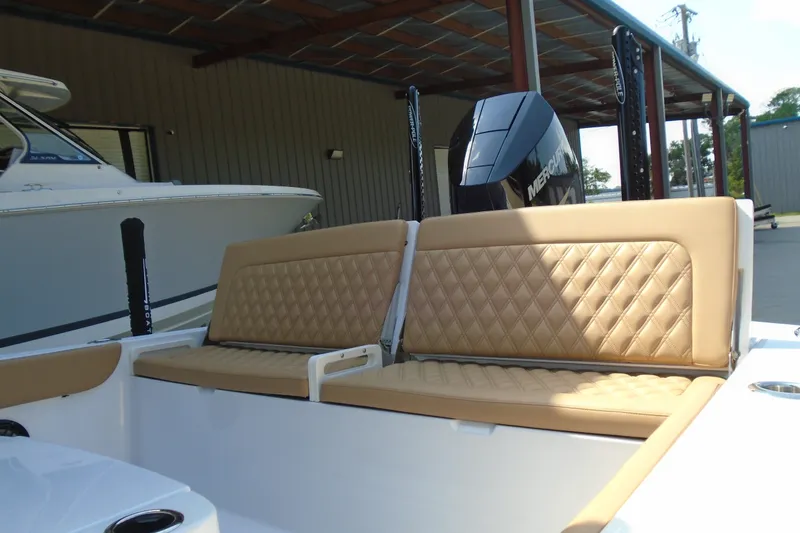 Slide: The Image of 2027 STRIKING BOATS 26XB with tan quilted seating and powerful outboard motor. - 4