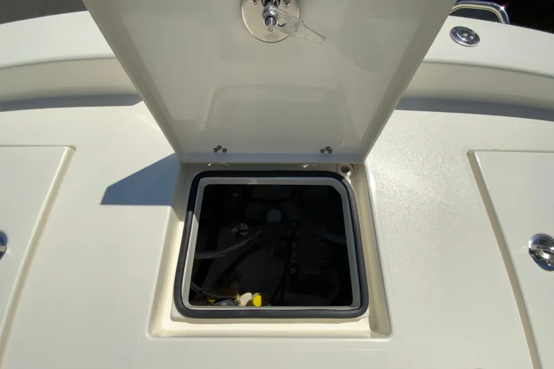 Slide: The Image of Open hatch on 2025 Pathfinder 2600 TRS boat deck, revealing storage compartment. - 24