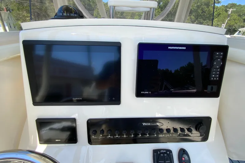 Slide: The Image of Control panel of 2025 Pathfinder 2600 TRS boat with Garmin and Humminbird displays. - 16