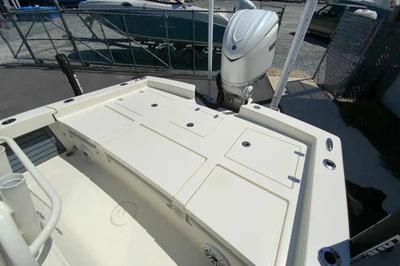 Slide: The Image of 2025 Pathfinder 2600 TRS boat deck with storage compartments and outboard motor. - 20
