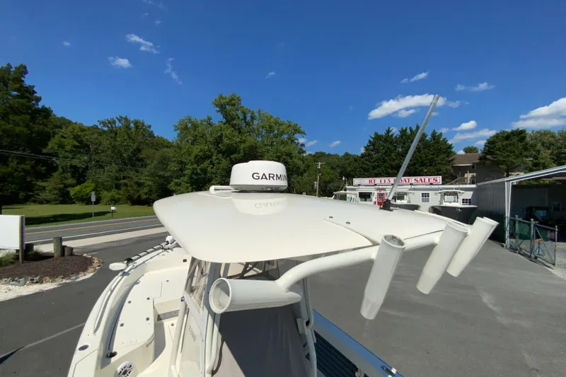Slide: The Image of 2025 Pathfinder 2600 TRS boat with Garmin radar, parked near a boat sales shop. - 46