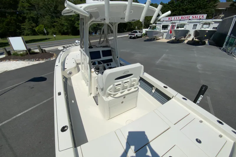 Slide: The Image of 2025 Pathfinder 2600 TRS boat at dealership, showcasing helm and seating area. - 14