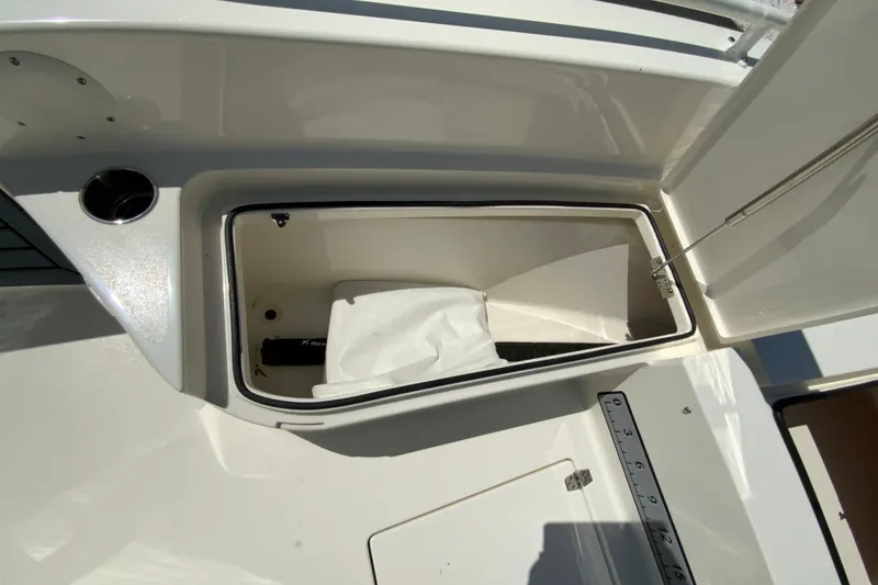 Slide: The Image of Open storage compartment on 2025 Pathfinder 2600 TRS boat, featuring a clean, white interior. - 29