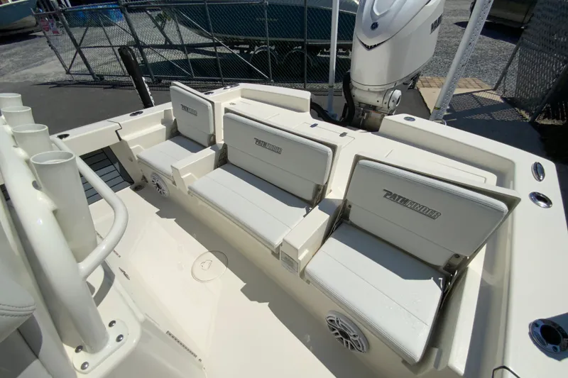 Slide: The Image of 2025 Pathfinder 2600 TRS boat interior with seating and motor, docked outdoors. - 23