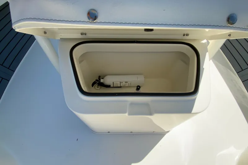 Slide: The Image of Open storage compartment on 2025 Pathfinder 2600 TRS boat with fire extinguisher inside. - 32