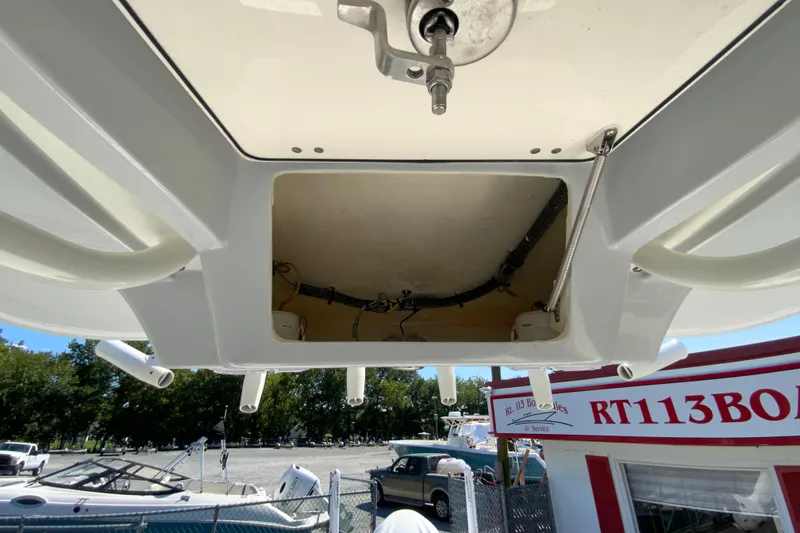 Slide: The Image of 2025 Pathfinder 2600 TRS boat interior view with open hatch and wiring. - 45