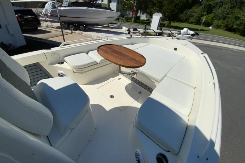 Slide: The Image of 2025 Pathfinder 2600 TRS boat interior with seating and a wooden table. - 36
