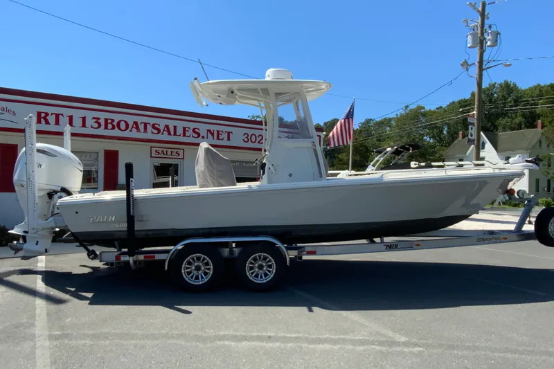 The Image of 2025 Pathfinder 2600 TRS boat on trailer outside dealership, showcasing sleek design and modern features. - 1