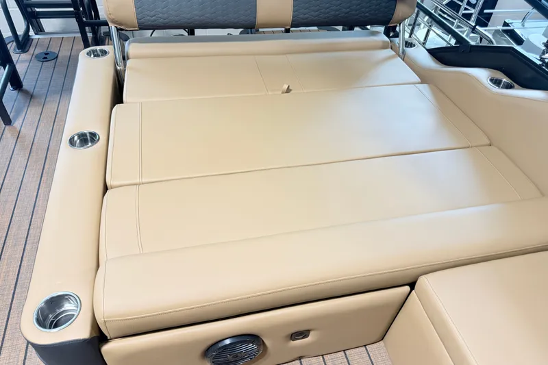 Slide: The Image of 2027 Bentley Pontoons Elite 223 Swingback Bench with luxurious beige seating and cup holders. - 14