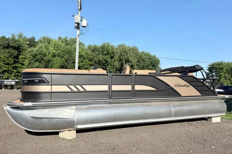 The Image of 2027 Bentley Pontoons Elite 223 Swingback Bench, sleek design, parked outdoors. - 0