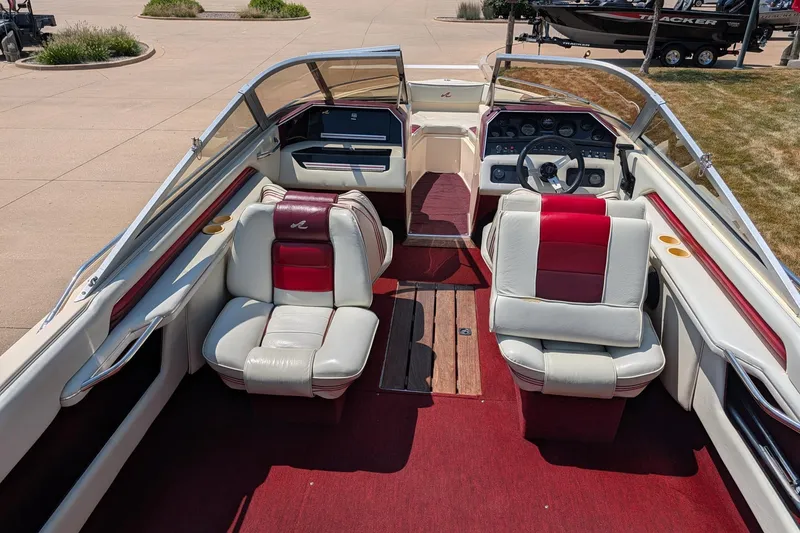 Slide: The Image of 1987 Sea Ray Sorrento 23 boat interior with red and white seating, dashboard, and steering wheel. - 9