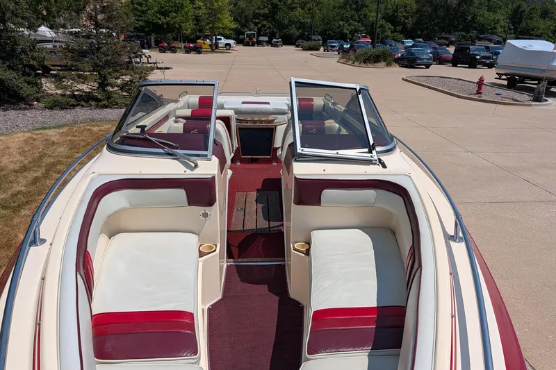 Slide: The Image of 1987 Sea Ray Sorrento 23 boat interior with red and white seating, parked outdoors. - 7