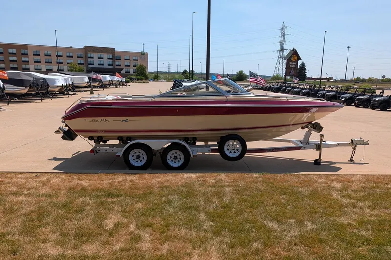 Slide: The Image of 1987 Sea Ray Sorrento 23 boat on trailer in outdoor dealership lot. - 3