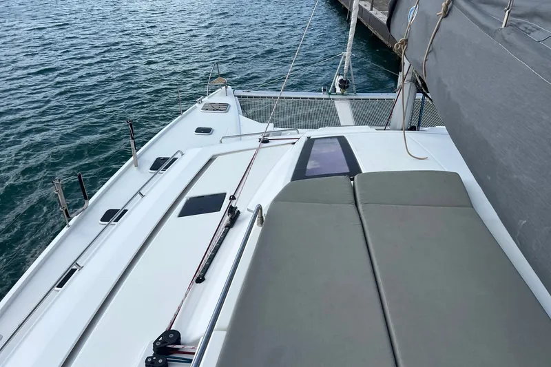Slide: The Image of 2021 Fountaine Pajot SABA 50 catamaran docked, showcasing deck and seating area. - 16