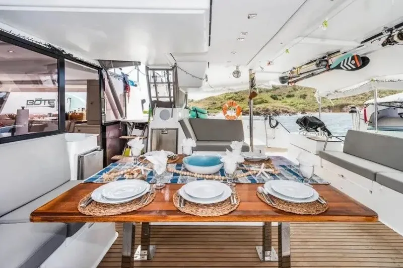 Slide: The Image of Luxurious dining setup on 2021 Fountaine Pajot SABA 50 catamaran, featuring elegant tableware. - 21