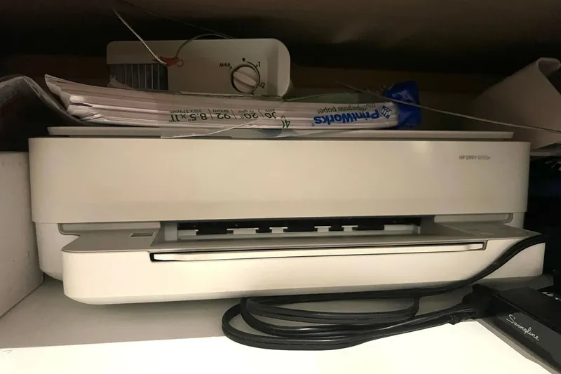 Slide: The Image of A white HP printer with stacked papers and a Swingline stapler nearby. - 67