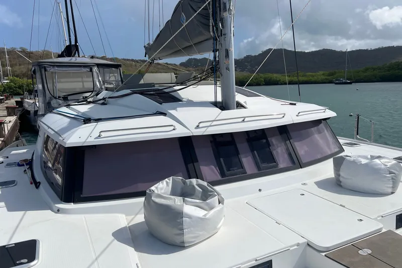 Slide: The Image of 2021 Fountaine Pajot SABA 50 catamaran docked, showcasing sleek design and spacious deck. - 13