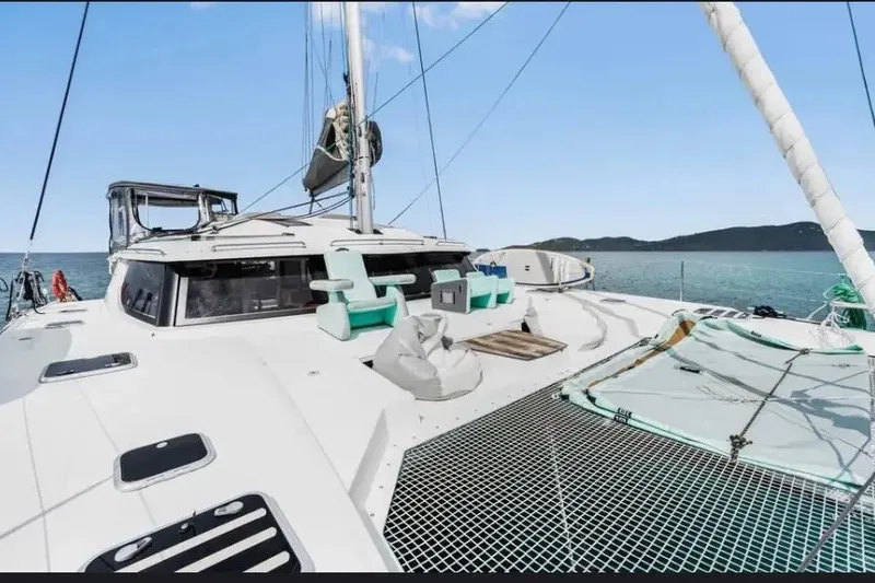 Slide: The Image of 2021 Fountaine Pajot SABA 50 catamaran on open water, featuring spacious deck and netting. - 15