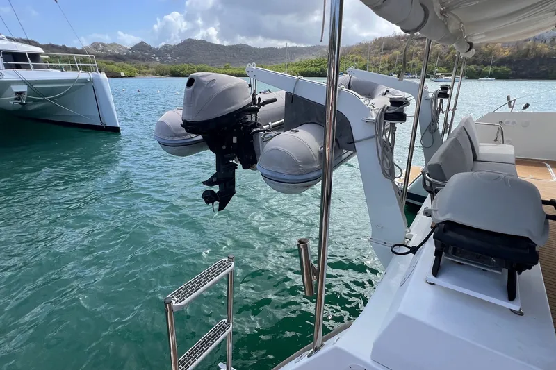 Slide: The Image of 2021 Fountaine Pajot SABA 50 catamaran with dinghy and outboard motor in scenic harbor. - 86
