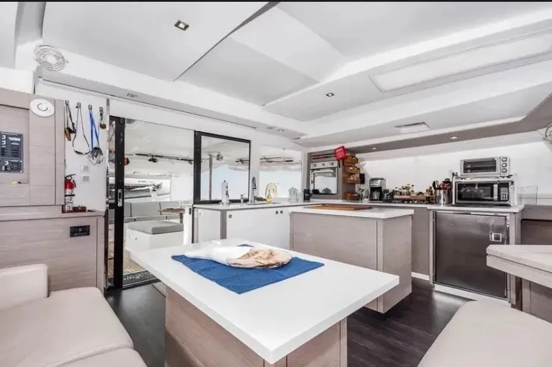 Slide: The Image of Modern interior of 2021 Fountaine Pajot SABA 50 catamaran, featuring sleek kitchen and dining area. - 24