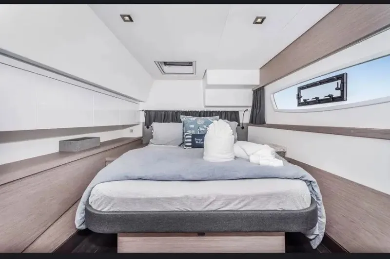 Slide: The Image of Luxurious cabin interior of 2021 Fountaine Pajot SABA 50 catamaran, featuring modern design and cozy bedding. - 35