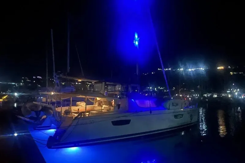 Slide: The Image of 2021 Fountaine Pajot SABA 50 yacht illuminated by blue lights at night. - 109