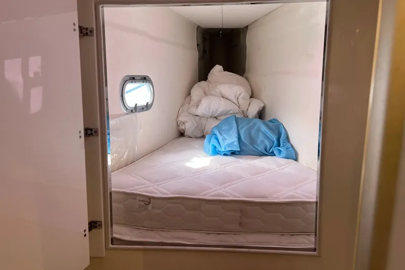 Slide: The Image of Small cabin interior with mattress and bedding on a 2021 Fountaine Pajot SABA 50 yacht. - 123