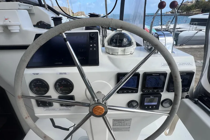 Slide: The Image of Helm of 2021 Fountaine Pajot SABA 50 catamaran with navigation instruments and steering wheel. - 54