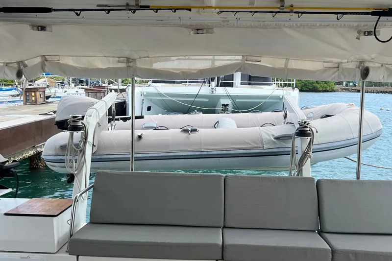 Slide: The Image of Fountaine Pajot SABA 50 catamaran with inflatable dinghy, docked in a marina, 2021 model. - 49