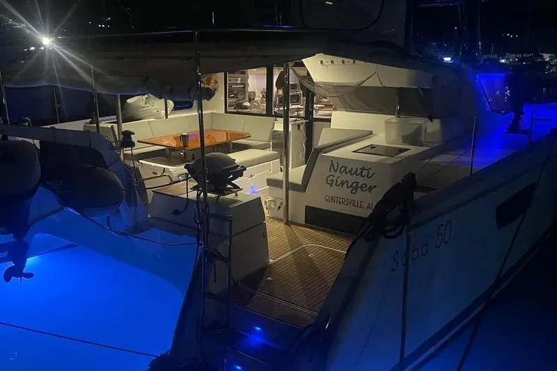 Slide: The Image of 2021 Fountaine Pajot SABA 50 catamaran illuminated at night with blue underwater lights. - 55