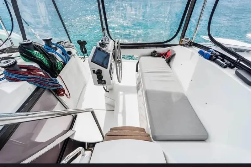 Slide: The Image of Cockpit of 2021 Fountaine Pajot SABA 50 catamaran with steering wheel and ocean view. - 44