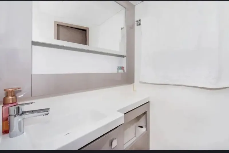 Slide: The Image of Modern bathroom interior on 2021 Fountaine Pajot SABA 50 yacht, featuring sleek sink and mirror. - 33