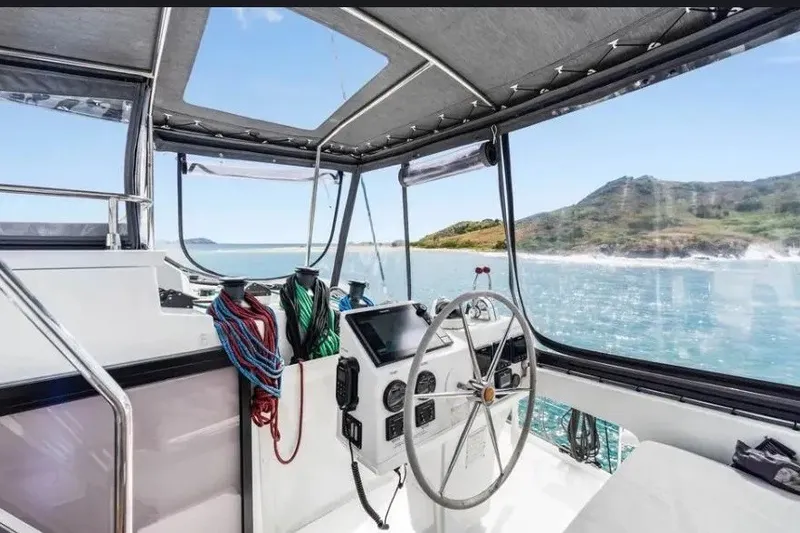 Slide: The Image of Helm of 2021 Fountaine Pajot SABA 50 catamaran with ocean view and modern controls. - 40