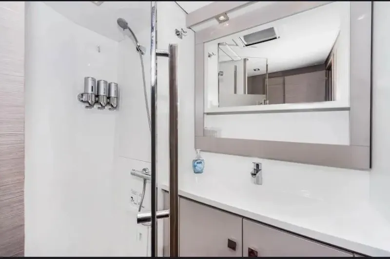 Slide: The Image of Modern bathroom interior of 2021 Fountaine Pajot SABA 50 yacht, featuring sleek fixtures and mirror. - 111