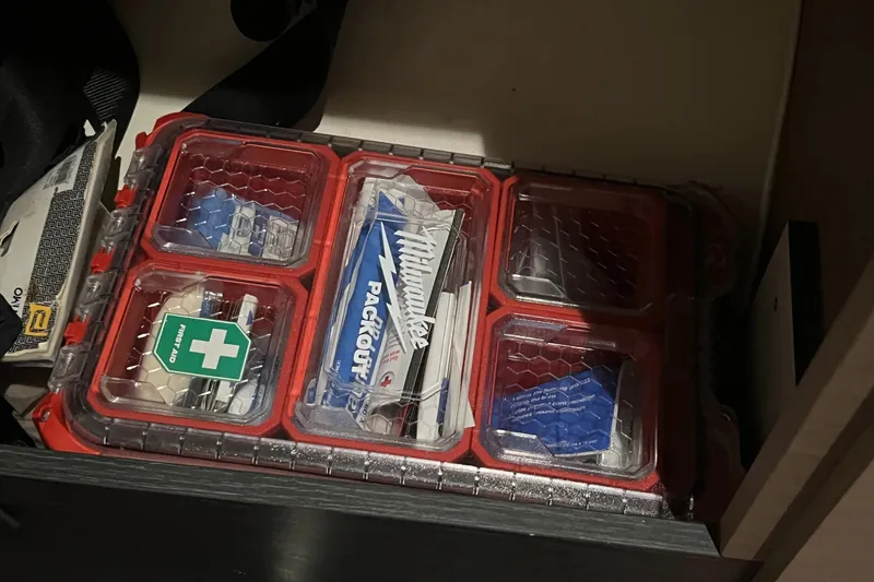 Slide: The Image of First aid kit and supplies in a storage compartment on a 2021 Fountaine Pajot SABA 50. - 69