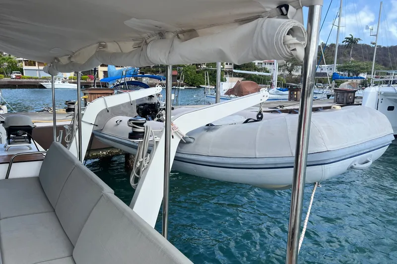 Slide: The Image of 2021 Fountaine Pajot SABA 50 catamaran with dinghy at marina, featuring spacious seating. - 117