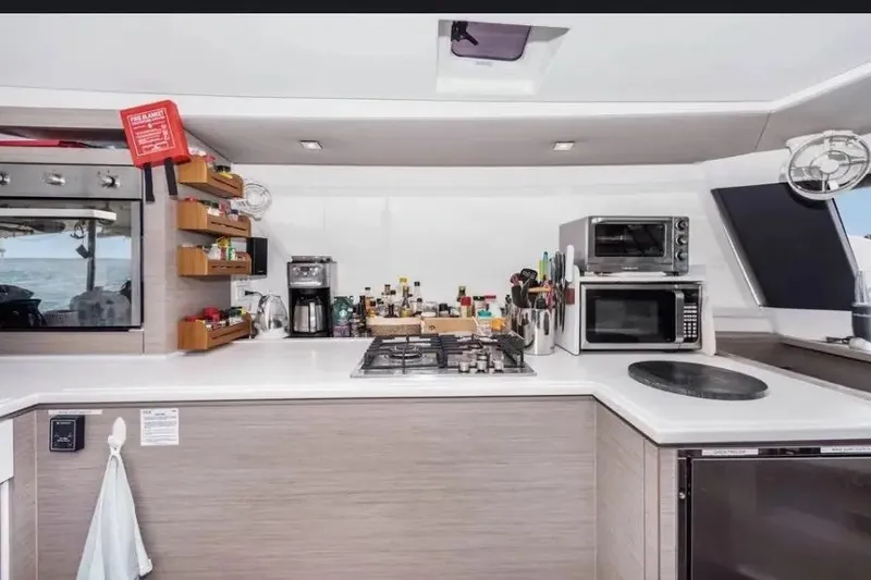 Slide: The Image of Modern kitchen interior on 2021 Fountaine Pajot SABA 50 yacht, featuring appliances and sleek design. - 25