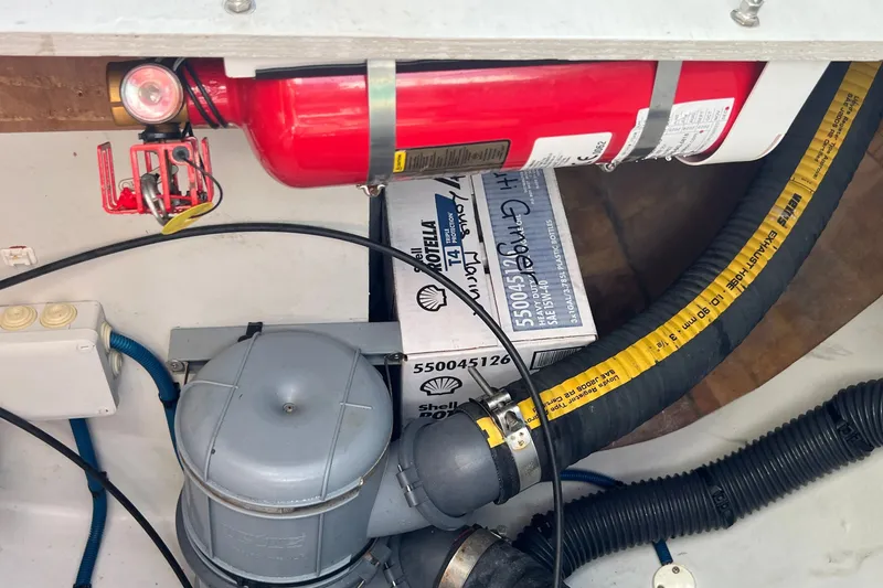 Slide: The Image of Engine compartment of 2021 Fountaine Pajot SABA 50 with fire extinguisher and hoses. - 74