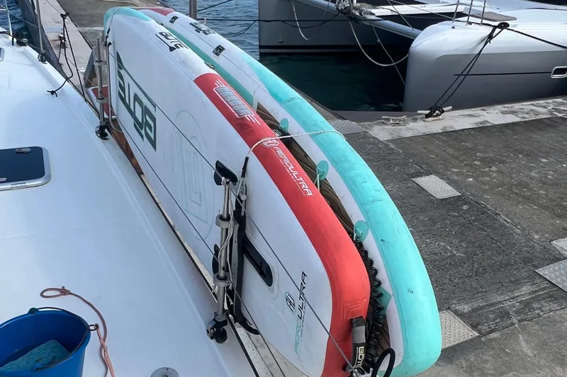 Slide: The Image of Paddleboards secured on a 2021 Fountaine Pajot SABA 50 catamaran at the dock. - 83