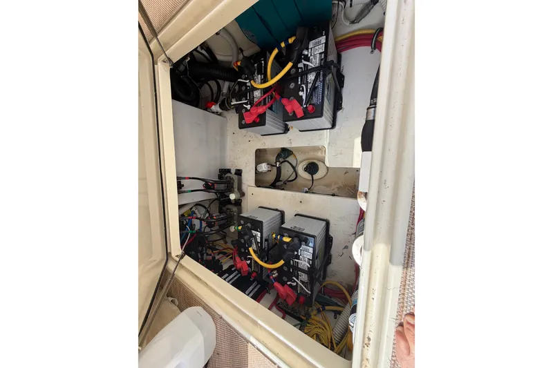 Slide: The Image of Engine compartment of a 2017 Chris-Craft Catalina 34, showcasing batteries and wiring. - 19
