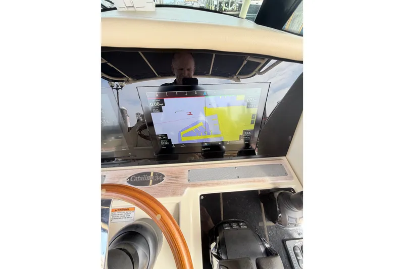 Slide: The Image of Helm of 2017 Chris-Craft Catalina 34 with navigation display and controls. - 41