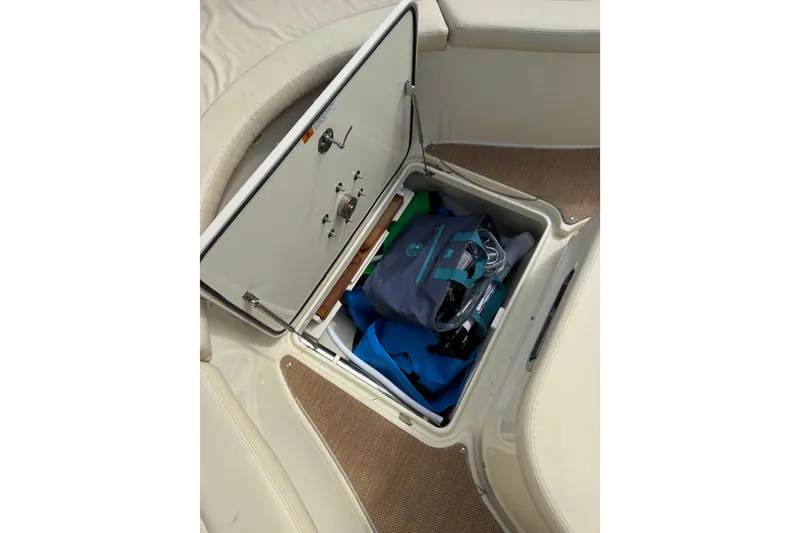 Slide: The Image of Storage compartment on a 2017 Chris-Craft Catalina 34 boat, containing bags and gear. - 33