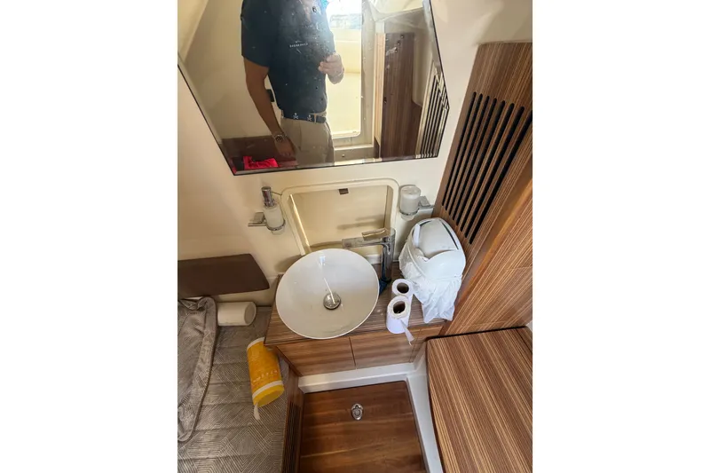Slide: The Image of 2017 Chris-Craft Catalina 34 bathroom with modern sink and wooden accents. - 25