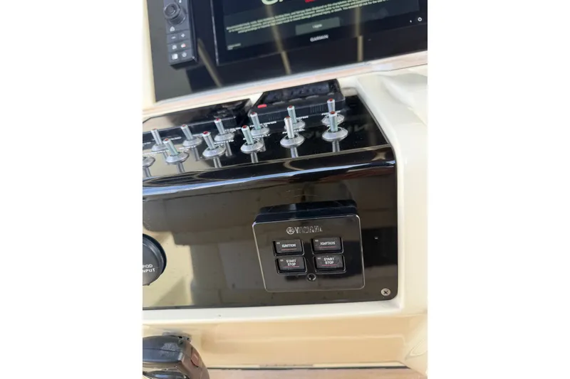 Slide: The Image of Control panel of a 2017 Chris-Craft Catalina 34 boat with switches and display. - 40