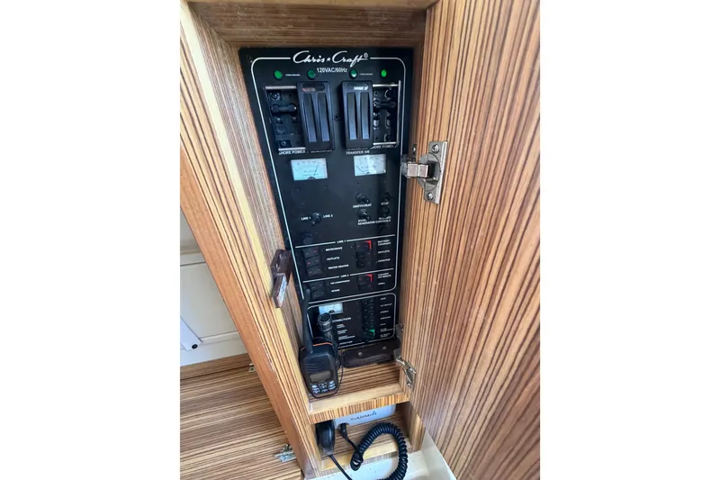 Slide: The Image of Electrical panel of a 2017 Chris-Craft Catalina 34 boat, featuring control switches and wiring. - 27