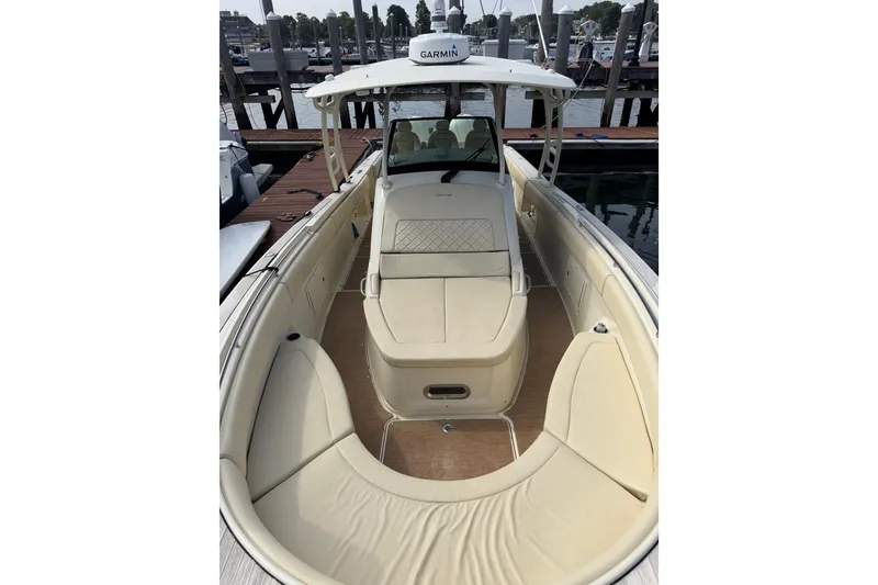 Slide: The Image of 2017 Chris-Craft Catalina 34 boat with beige seating, docked at a marina. - 30