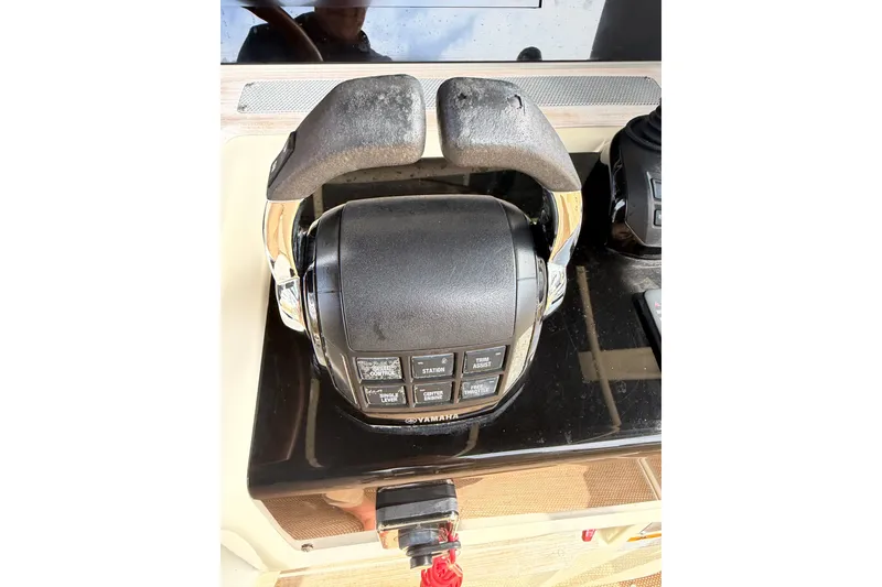 Slide: The Image of Throttle controls on a 2017 Chris-Craft Catalina 34 boat dashboard. - 39